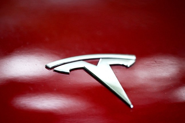 This photograph taken on October 23, 2025 shows a Tesla logo on the body of car parked in Warsaw. (Photo by Sergei GAPON / AFP) (Photo by SERGEI GAPON/AFP via Getty Images)