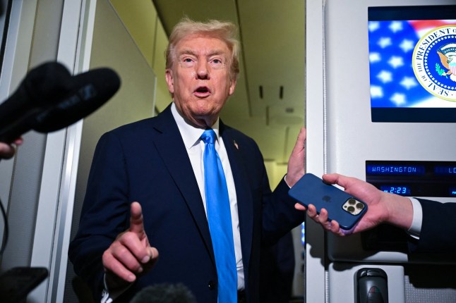 TOPSHOT - US President Donald Trump speaks to the media following his meeting with Qatar's Emir Sheikh Tamim bin Hamad Al-Thani and Prime Minister and Foreign Minister Sheikh Mohammed bin Abdulrahman bin Jassim Al-Thani aboard Air Force One in Doha on October 25, 2025, as he makes a refuelling stop on his way to Malaysia for the ASEAN summit. (Photo by ANDREW CABALLERO-REYNOLDS / AFP) (Photo by ANDREW CABALLERO-REYNOLDS/AFP via Getty Images)