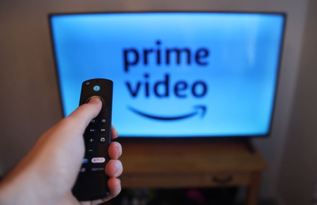 The remote control of an Amazon Fire stick is displayed on January 22, 2024 with Amazon Prime logo on a TV on the background.