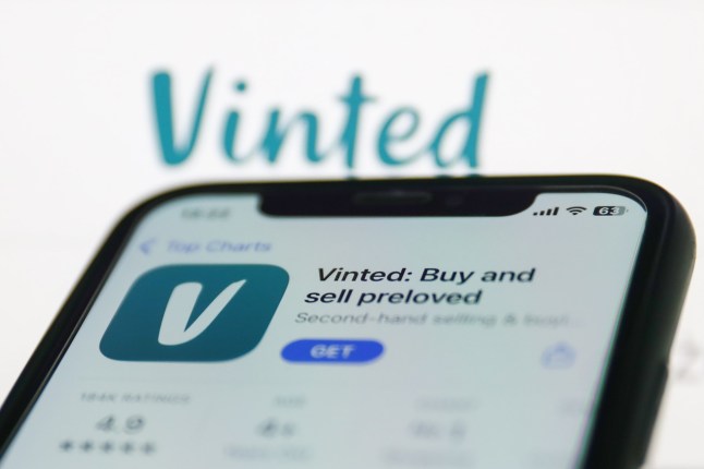 Vinted on App Store displayed on a phone screen and Vinted website displayed on a screen in the background are seen in this illustration photo taken in Krakow, Poland on January 19, 2023. (Photo by Jakub Porzycki/NurPhoto via Getty Images)