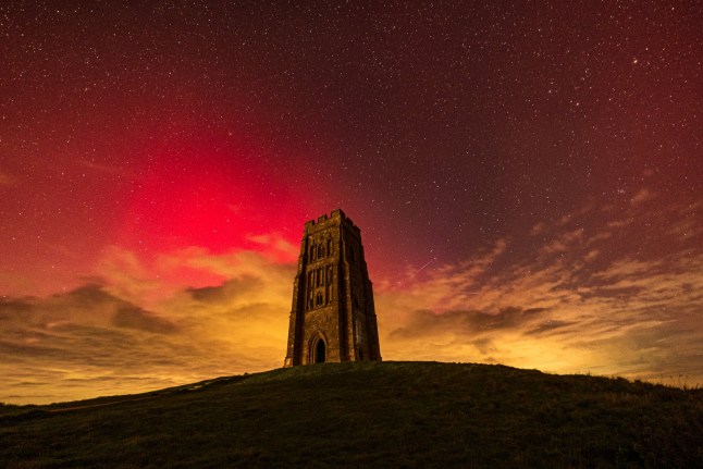 Northern Lights over Glastonbury Tor, Somerset. October 11 2024. Photo released October 11 2024.