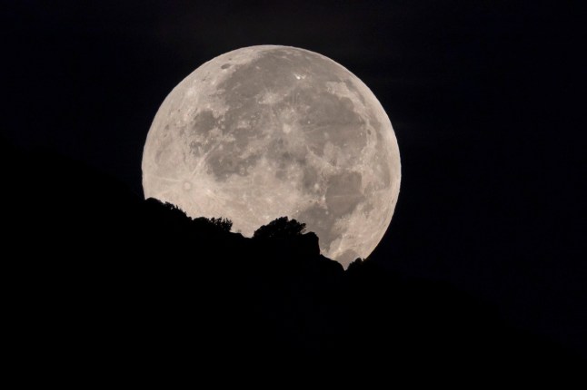 epa12436314 The first supermoon of the year, also known as the Harvest Moon, is seen over Mallorca, Spain's Balearic Islands, early 07 October 2025. EPA/CATI CLADERA