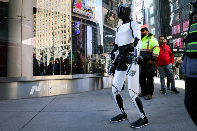 A Tesla Optimus robot walks during an appearance outside the Nasdaq Market site in New York City, U.S., October 27, 2025. REUTERS/Brendan McDermid