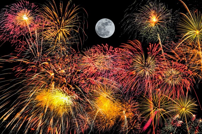 set of fireworks on black background with super moon