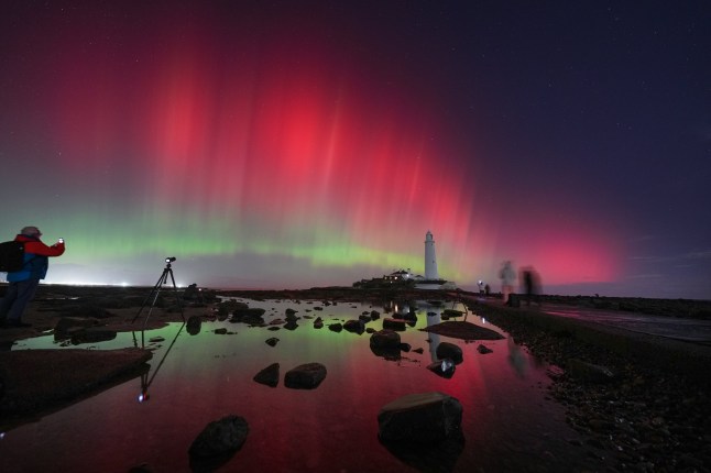 The aurora borealis, also known as the northern lights, glow in the sky over St Mary's Lighthouse in Whitley Bay on the North East coast, reaching a G4 level geomagnetic storm, putting on an amazing display in the early hours. Picture date: Wednesday November 12, 2025. PA Photo. Photo credit should read: Owen Humphreys/PA Wire