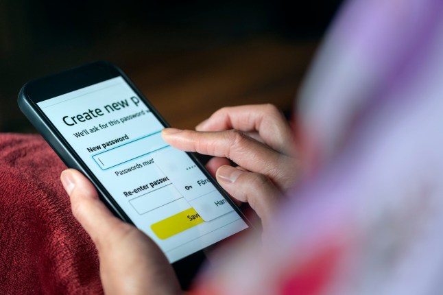 Close-up of resetting password on mobile phone