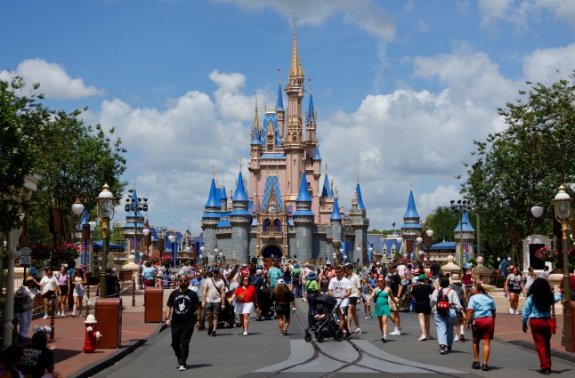 People walk past the front of Cinderella's Castle at the Magic Kingdom Park at Walt Disney World on April 3, 2025, in Orlando, Florida. (Photo by Gary Hershorn/Getty Images)