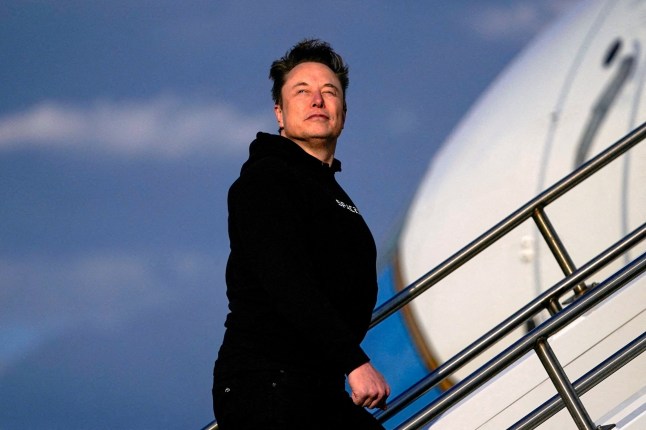 FILE PHOTO: Tesla CEO Elon Musk boards Air Force One with U.S. President Donald Trump (not pictured) as they depart for Philadelphia, Pennsylvania, from Morristown Municipal Airport in Morristown, New Jersey, U.S., March 22, 2025. REUTERS/Nathan Howard/File Photo/File Photo