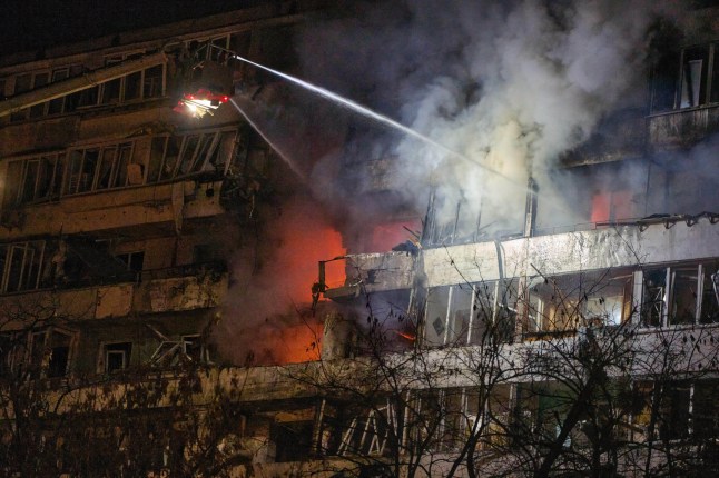 Firefighters put out the fire after a drone hit a multi-storey residential building during Russia's night drone attack in Kyiv, Ukraine, Tuesday, Nov. 25, 2025. (AP Photo/Efrem Lukatsky)