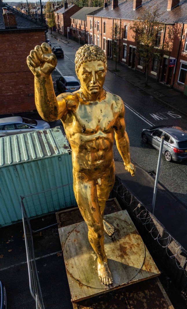 Aerial images of a controversial 20-foot-tall nude statue banned by a local council which has been reinstated - after a campaign by dozens of locals. The striking gold Roman Gladiator statue - once used to promote the Russell Crowe blockbuster in 2000 - was re-erected at Bulldog Forge, in Ince, Wigan, Greater Manchester, earlier this week (Nov 26). A controversial 20-foot-tall nude statue banned by a local council has been reinstated - after a campaign by dozens of locals. The striking gold Roman Gladiator statue - once used to promote the Russell Crowe blockbuster in 2000 - was re-erected at Bulldog Forge, in Ince, Wigan, Greater Manchester, earlier this week (Nov 26).The much-loved figure - known to locals as 'Golden Balls' - was taken down on October 11 2022 after Wigan Council ordered its removal following a number of complaints from neighbours.The decision caused backlash in the community who later set up Facebook pages and petitions for him to be returned. Photo released 30/11/2025