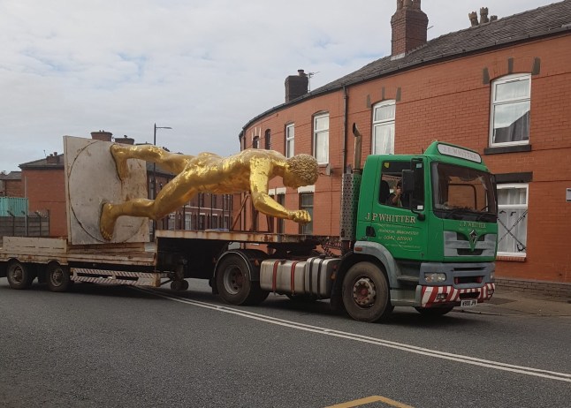 Images show the Wigan Council moving the golden nude statue on the back of a truck. A controversial 20-foot-tall nude statue banned by a local council has been reinstated - after a campaign by dozens of locals. The striking gold Roman Gladiator statue - once used to promote the Russell Crowe blockbuster in 2000 - was re-erected at Bulldog Forge, in Ince, Wigan, Greater Manchester, earlier this week (Nov 26). A controversial 20-foot-tall nude statue banned by a local council has been reinstated - after a campaign by dozens of locals. The striking gold Roman Gladiator statue - once used to promote the Russell Crowe blockbuster in 2000 - was re-erected at Bulldog Forge, in Ince, Wigan, Greater Manchester, earlier this week (Nov 26).The much-loved figure - known to locals as 'Golden Balls' - was taken down on October 11 2022 after Wigan Council ordered its removal following a number of complaints from neighbours.The decision caused backlash in the community who later set up Facebook pages and petitions for him to be returned. Photo released 30/11/2025