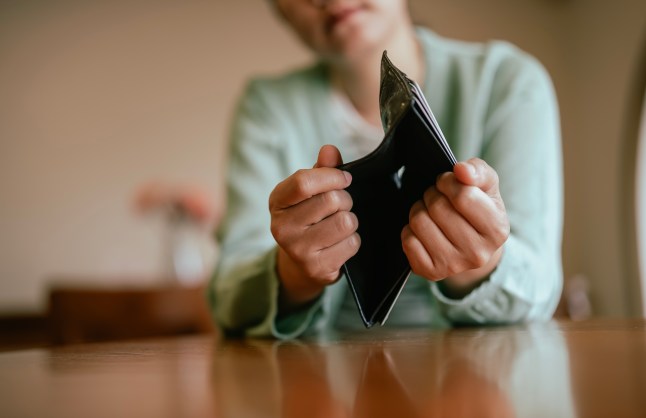 Asian Young Woman Holding Empty Wallet in Financial Crisis
