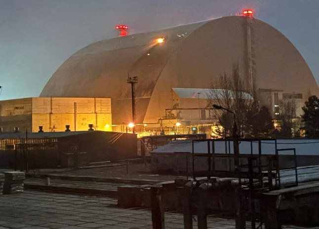 A handout images taken from the X account of the International Atomic Energy Agency (IAEA) on February 14, 2025 shows a glow after an UAV apparently had struck the roof at the New Safe Confinement (NSC), which protects the remains of reactor 4 of the former Chornobyl NPP, causing a fire. Ukrainian's president said on February 14, that a Russian drone had struck overnight a cover built to contain radiation at the Chernobyl nuclear power plant, adding that "radiation levels have not increased".