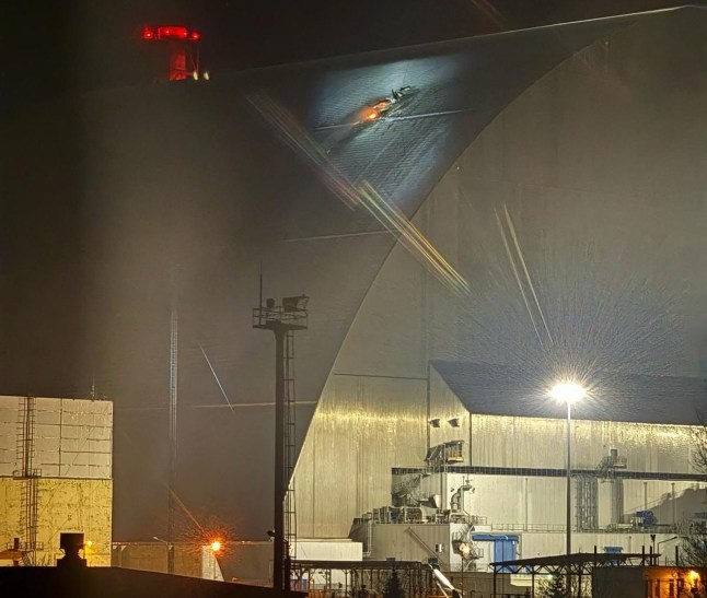 A handout images taken from the X account of the International Atomic Energy Agency (IAEA) on February 14, 2025 shows a glow after an UAV apparently had struck the roof at the New Safe Confinement (NSC), which protects the remains of reactor 4 of the former Chornobyl NPP, causing a fire. Ukrainian's president said on February 14, that a Russian drone had struck overnight a cover built to contain radiation at the Chernobyl nuclear power plant, adding that "radiation levels have not increased". (Photo by Handout / International Atomic Energy Agency (IAEA)