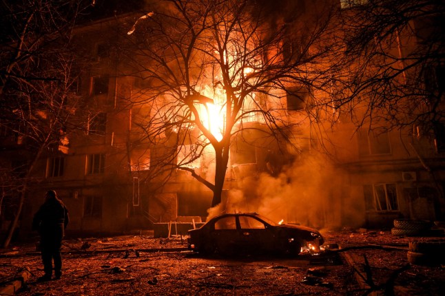 This photo cannot be distributed in the Russian Federation. Mandatory Credit: Photo by Ukrinform/Shutterstock (15941637m) A man stands near a car burning under a tree outside a residential building that is engulfed by flames after being hit by a Russian drone, Zaporizhzhia, Ukraine, November 25, 2025. On Tuesday evening, November 25, Zaporizhzhia came under attack from Russian strike drones. The city suffered extensive damage to civilian housing infrastructure. Several large-scale fires were reported. Nineteen people were injured in the attack. (Photo by Dmytro Smolienko/Ukrinform) Russian army attacks Zaporizhzhia with drones, Ukraine - 25 Nov 2025