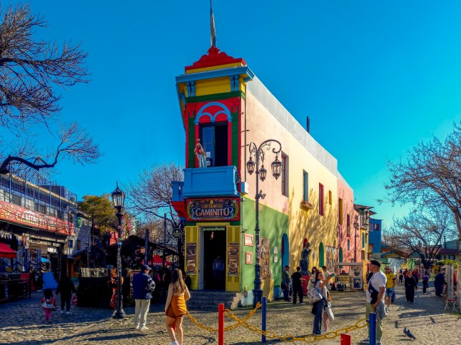 Buenos Aires, Argentina; Aug 26, 2025: Balcony in the colorful Caminito street in La Boca neighborhood flanked by an old streetlight