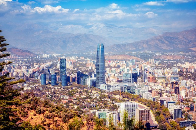 wide elevated panoramic view on modern Santiago skyline with mountain range in the background