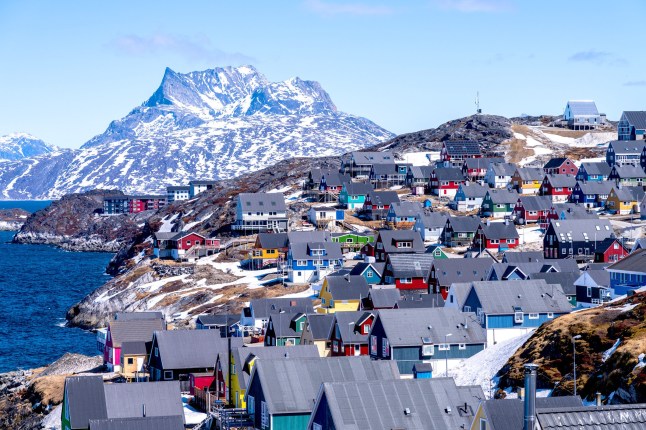 Scenic view of colorful houses nestled along the coast of Nuuk, Greenland, with Sermitsiaq mountain in the background