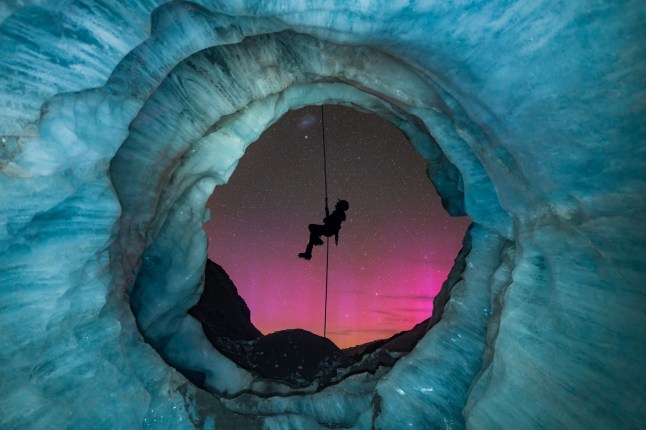Northern Lights photographer of the year 2025 T&Cs MUST CREDIT PHOTOGRAPHER AND @capturetheatlas FOR SOCIAL MEDIA SHARING. ?Lights & Ice? by Tori Harp . I originally found this ice cave, called a moulin, 8 months prior to setting up this shot in Aoraki/Mount Cook National Park. Glaciers are a very dynamic environment, so I kept going back to monitor the changes of this moulin over the 8-month period. As the opening of the cave formed, I envisioned setting up a night shot with my friend abseiling down the mouth of the cave with New Zealand???s amazing starry sky in the background. One magical night, everything finally came together! To my surprise, the Aurora Australis also lit up the sky. I managed to capture my friend???s silhouette perfectly placed in the center of the cave???s opening, and I love how the pinky tones of the aurora contrast with the icy colors of the cave. This dream shot ended up coming out better than I had originally envisioned, and I had a great night with my friends exploring the glacier!