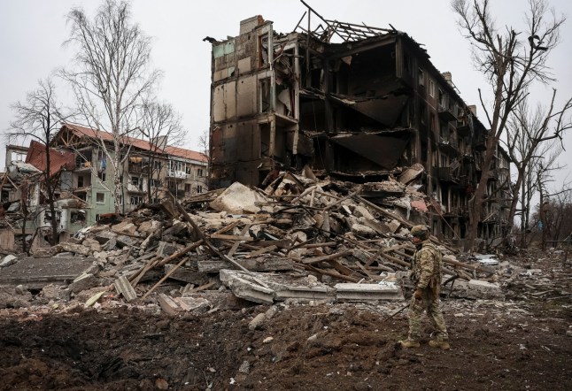 A member of the White Angel unit of Ukrainian police officers, who evacuate people from the frontline towns and villages, checks an area for residents, amid Russia's attack on Ukraine, in the frontline town of Dobropillia in Donetsk region, Ukraine December 9, 2025. REUTERS/Anatolii Stepanov