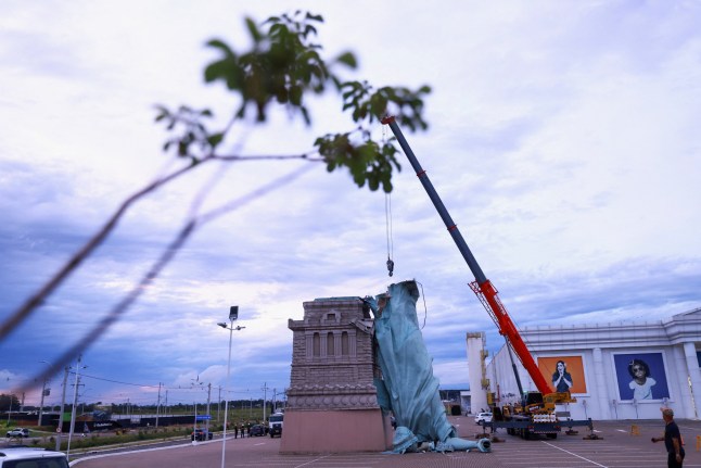 A replica of the Statue of Liberty, a symbol of Brazilian retailer Havan, lies toppled after strong winds struck the city of Guaiba, Brazil.