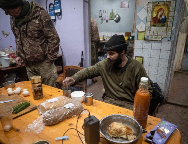 epa12598587 A handout picture made available by the press service of the 93rd Kholodnyi Yar Separate Mechanized Brigade of Ukrainian Armed Forces on 17 December 2025 shows servicemen of the 93rd Mechanized Brigade providing food for their comrades Denis, call sign 'Bars', and Dmytro, call sign 'K2???, following their return from positions near the Kostyantynivka, where they fought for 130 days straight, in the Donetsk region, Ukraine, 16 December 2025, amid the ongoing Russian invasion. Russian troops entered Ukrainian territory on 24 February 2022, starting a conflict that has provoked destruction and a humanitarian crisis. EPA/Press service of the 93rd Separate Mechanized Brigade HANDOUT HANDOUT EDITORIAL USE ONLY/NO SALES
