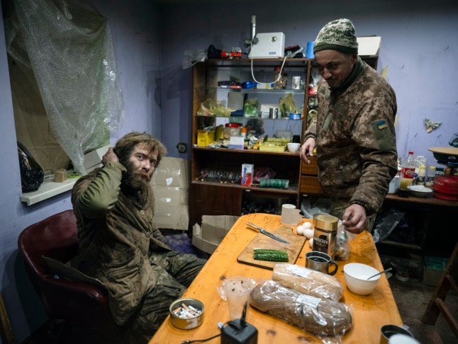 epa12598588 A handout picture made available by the press service of the 93rd Kholodnyi Yar Separate Mechanized Brigade of Ukrainian Armed Forces on 17 December 2025 shows servicemen of the 93rd Mechanized Brigade providing food for their comrades Denis, call sign 'Bars', and Dmytro, call sign 'K2???, following their return from positions near the Kostyantynivka, where they fought for 130 days straight, in the Donetsk region, Ukraine, 16 December 2025, amid the ongoing Russian invasion. Russian troops entered Ukrainian territory on 24 February 2022, starting a conflict that has provoked destruction and a humanitarian crisis. EPA/Press service of the 93rd Separate Mechanized Brigade HANDOUT HANDOUT EDITORIAL USE ONLY/NO SALES