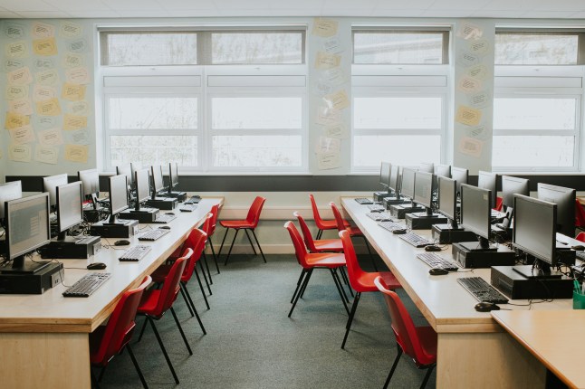 A computer lab in a high school building filled with modern technology.