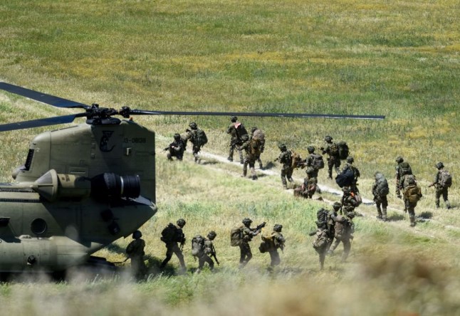 British soldiers deploy from a US helicopter during the Swift Response 22 military exercise at the Krivolak Military Training Center in Negotino