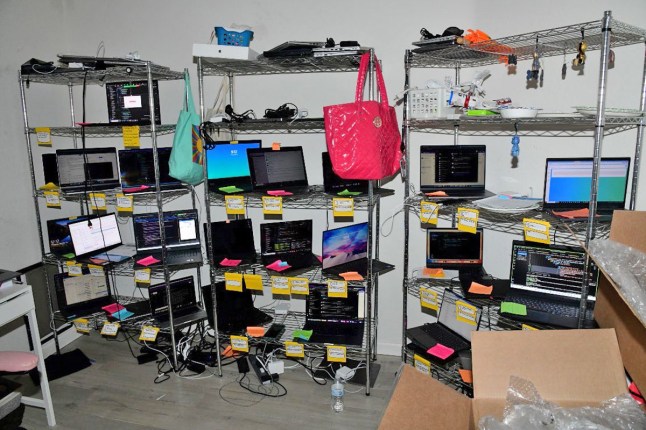 Laptop farm operated by Christina Chapman for North Korea, photographed during a government raid of her home in October 2023