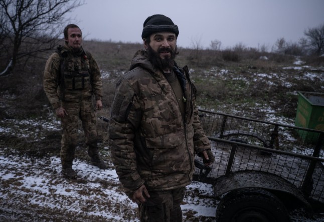 A Ukrainian soldier pictured (Dmitry, 30) with a haunting stare as he returned from the frontline has revealed how he had to dig himself out after being buried in an explosion.