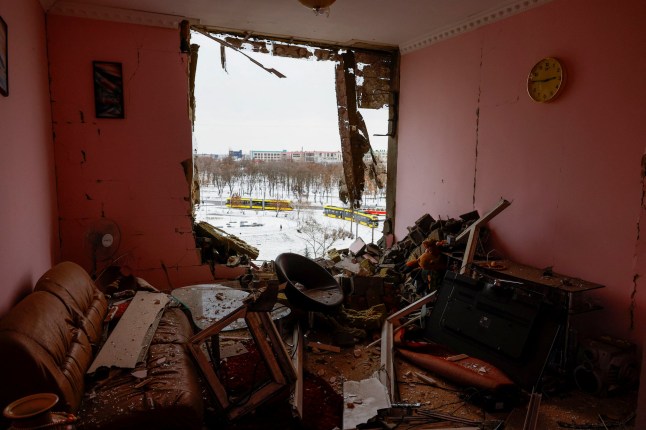 Debris is scattered around a destroyed window opening, with trams seen in the background, at the site of an apartment building hit during Russian missile and drone strikes, amid Russia???s attack on Ukraine in Kyiv, Ukraine December 27, 2025. REUTERS/Valentyn Ogirenko