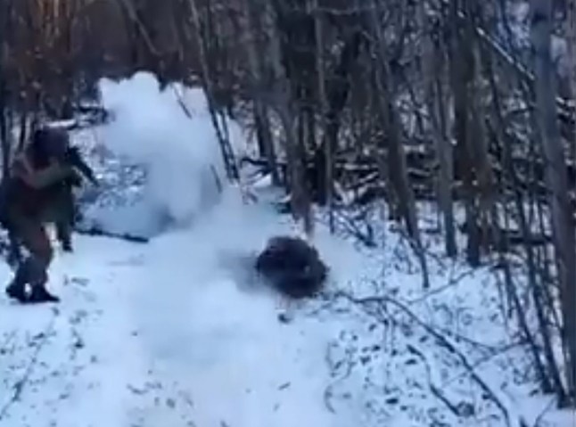 A North Korean soldier fighting for Putin in Ukraine is seen enjoying a ride in the snow until his sledge explodes a mine.